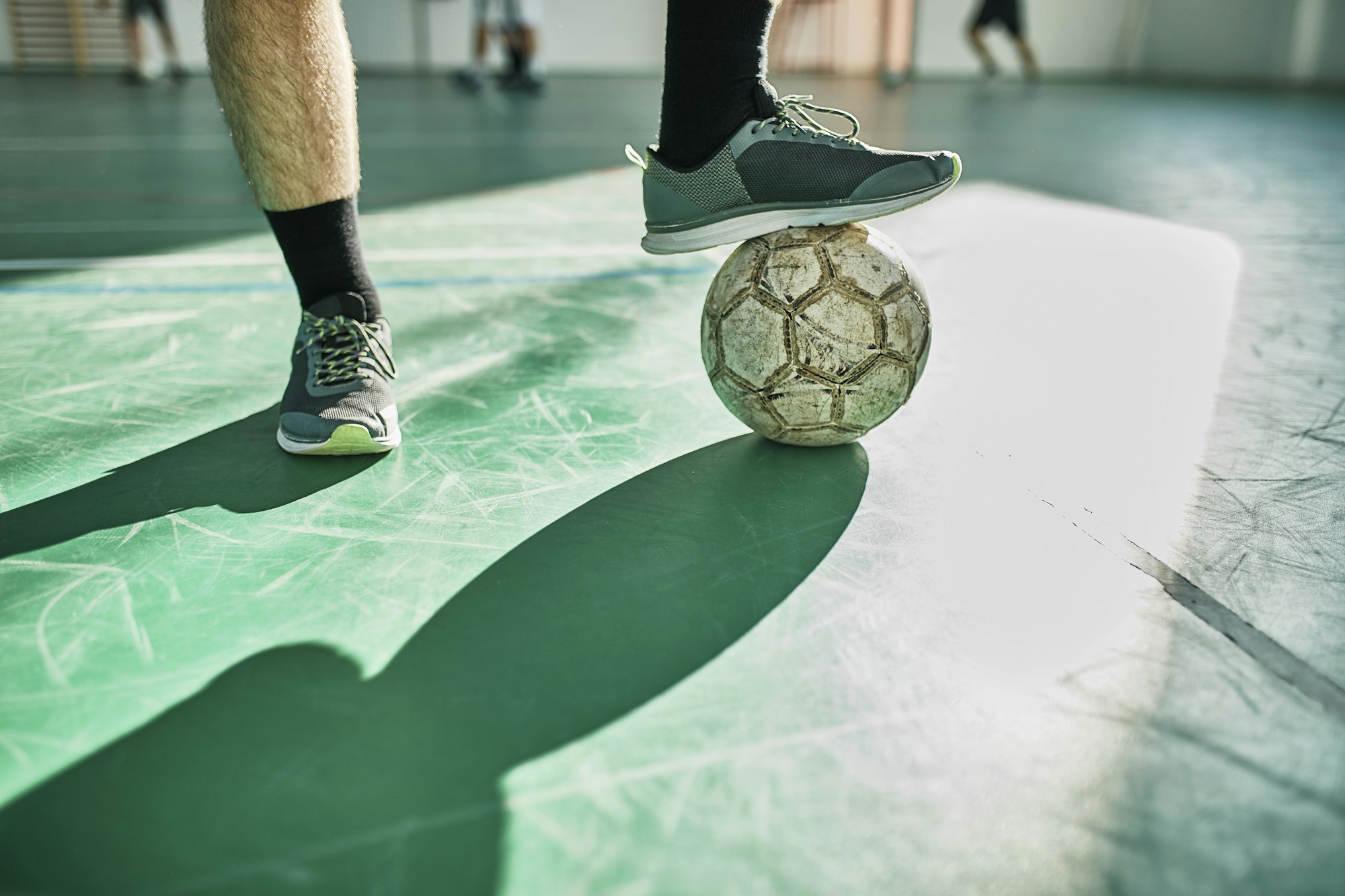 Close-up of indoor soccer player with ball