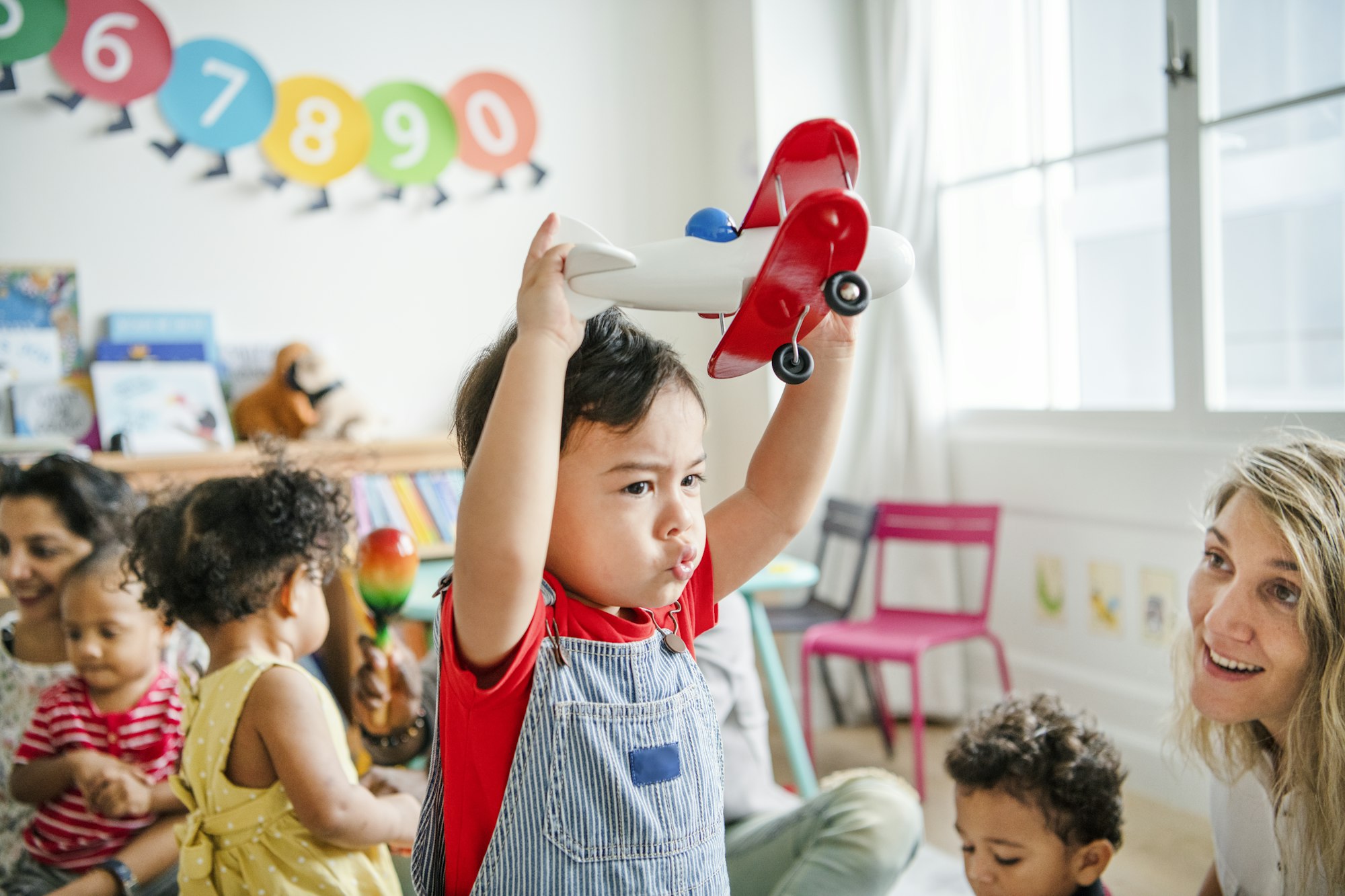 Preschooler enjoying playing with his airplane toy